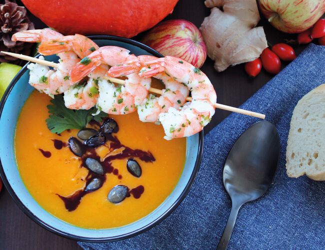 Pumpkin soup with prawn skewers